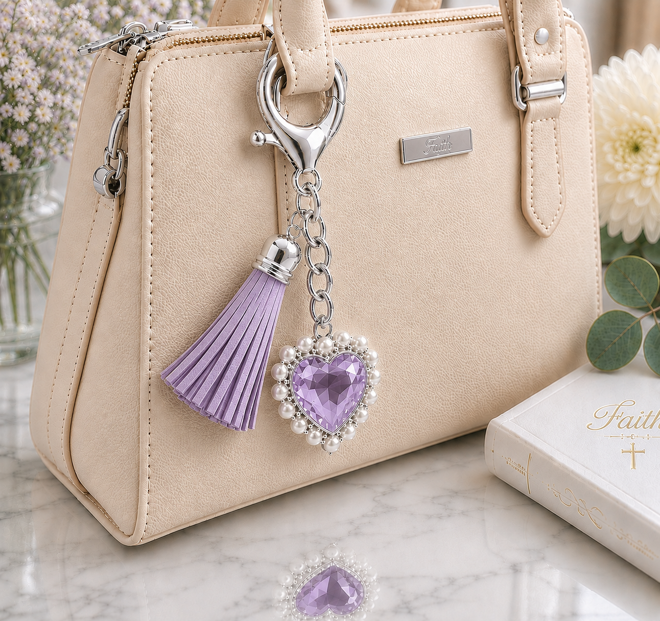 Courage Christian heart keychain with lilac crystal heart and tassel attached to beige handbag