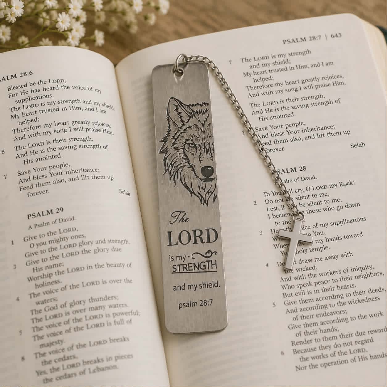 Metal bookmark with wolf design and 'The Lord is my Strength' text on an open book.